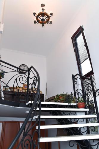 a set of stairs with a chandelier at Sofia in Kutaisi