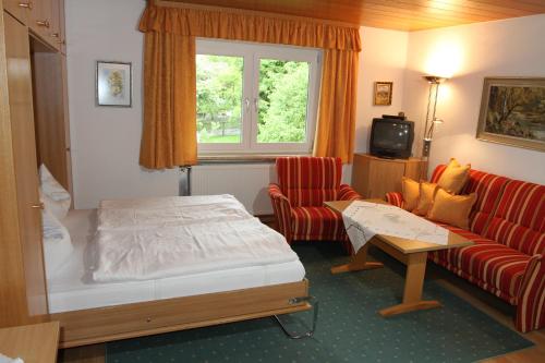 a hotel room with a bed and a couch at Appartementhaus Moos in Lam