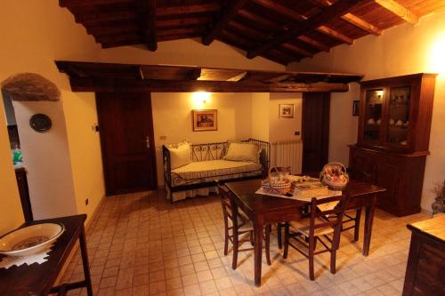 a living room with a table and a couch at Residenza La Torre in Santo Stefano di Sessanio