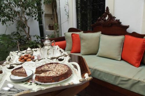 a table with a cake on top of a couch at El Patio Courtyard House in Tunis