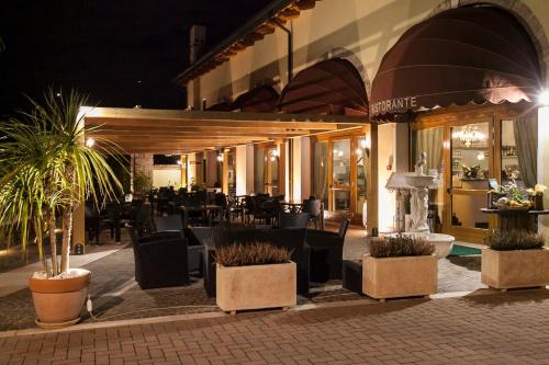 a restaurant with tables and chairs in front of a building at Albergo Antica Corte Marchesini in Campagna Lupia