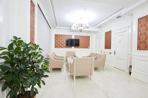 a meeting room with a table and chairs and a tv at NOBEL Hotel in Baku