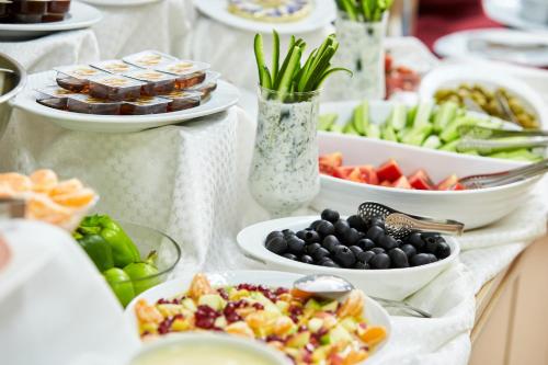 a buffet with plates of food on a table at NOBEL Hotel in Baku