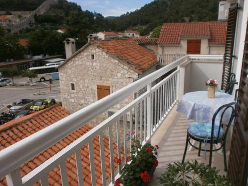 a balcony with a table and a view of a building at Guest House Zaninović in Hvar