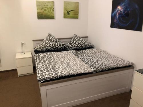 a bed with two pillows on it in a room at Linas Wohlfühloase Hameln in Hessisch Oldendorf