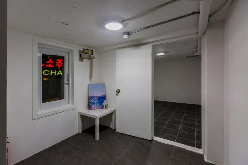 an empty room with a table and a window at MJ Stay 2 in Seoul