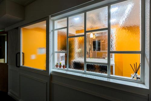 a window in a room with yellow walls at MJ Stay 2 in Seoul