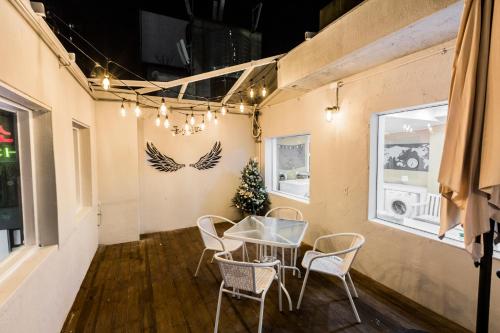 a dining room with a glass table and chairs at MJ Stay 2 in Seoul