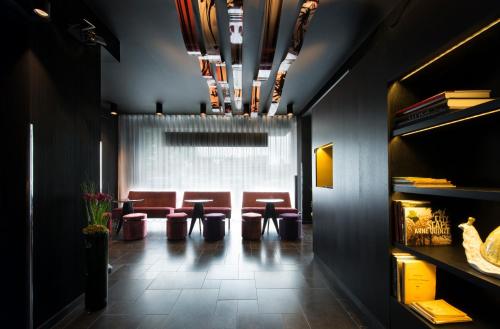 a waiting room with stools and a row of chairs at Hotel The Royal Snail in Namur
