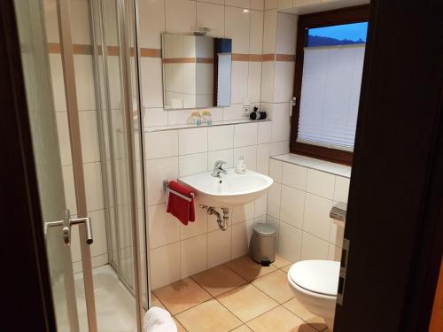 a bathroom with a sink and a toilet at Hotel Haupt in Kobern-Gondorf