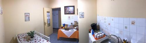 a hallway with a sink and a table in a room at B&B RoGe in Olbia