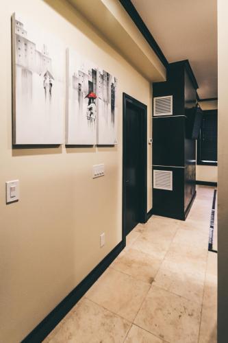 a hallway with pictures on the wall and a door at Ultra lux apartment steps from Brown and RISD in Providence