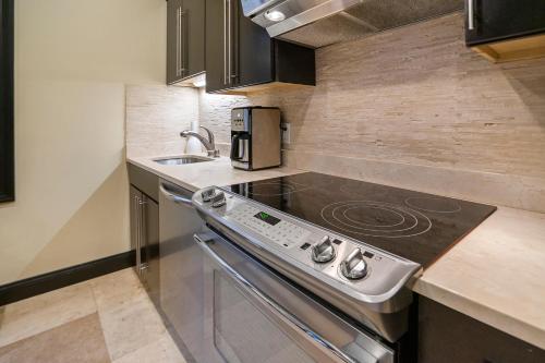a kitchen with a stove and a sink at Ultra lux apartment steps from Brown and RISD in Providence