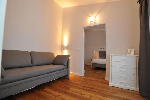 a living room with a couch and a bedroom at Baita Fanti Ski & Bike in Bormio
