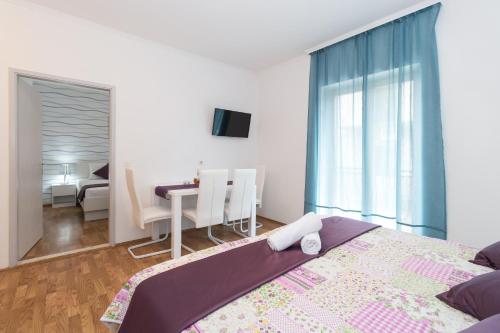 a bedroom with a bed and a desk in a room at Villa Voinic 2 in Cavtat