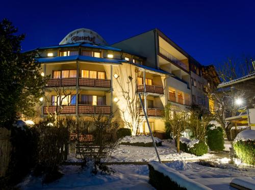 a building in the snow at night at Hotel Moserhof in Seeboden