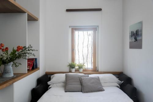 a room with a bed with pillows on it at Agora Apartments in Sorrento