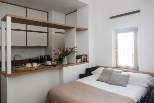 a small bedroom with a bed and a sink at Agora Apartments in Sorrento