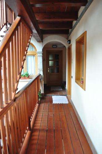 an empty porch with a wooden deck with a door at Ai Vellutai in Ala