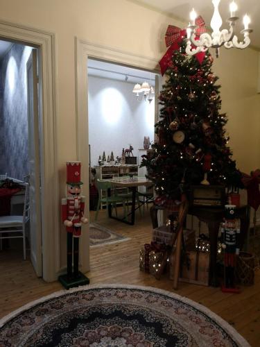 a living room with a christmas tree and a table at Sali Boutique hotel in Alexandroupoli