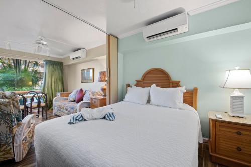 a bedroom with a bed and a living room at Caribbean Beach Club in Fort Myers Beach