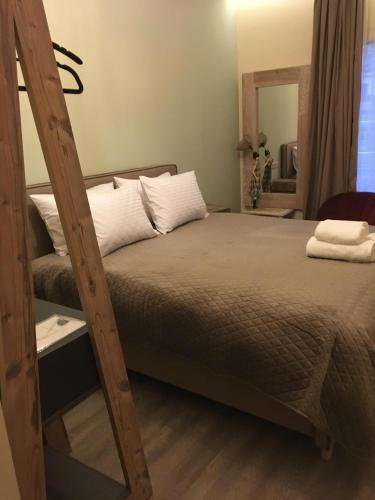 a bedroom with a bed and a mirror at Sali Boutique hotel in Alexandroupoli
