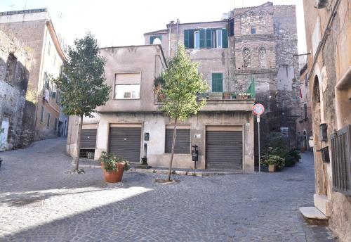 a building with two garage doors on a street at La Casa di Nonna in Tivoli