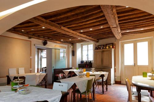 a restaurant with tables and chairs in a room at Hotel Alla Corte degli Angeli in Lucca