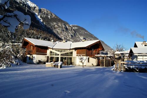 a lodge in the snow with a mountain in the background at Haus Salzmann in Pfunds