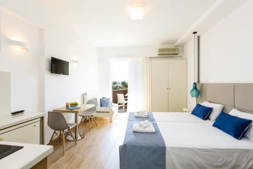 a bedroom with a large bed and a kitchen at Eltina Hotel in Rethymno Town