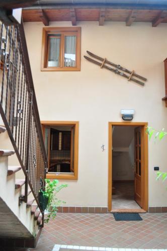 a house with a staircase and a door at Ai Vellutai in Ala