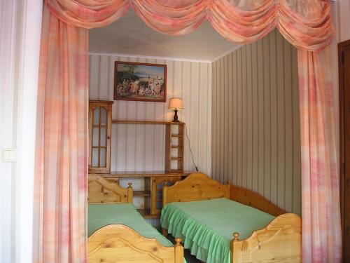 a bedroom with two beds and a window with curtains at Odesos Apartments in Varna City