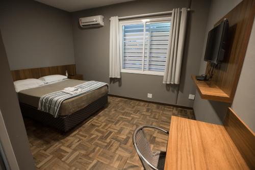 Cama o camas de una habitación en Ipê Hotel Express