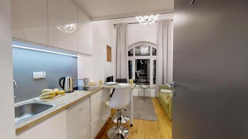 a kitchen with a sink and a counter top at Aparthotel Tectum TectumApartments in Wrocław