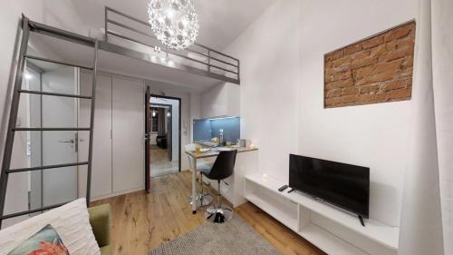a living room with a television and a desk at Aparthotel Tectum TectumApartments in Wrocław
