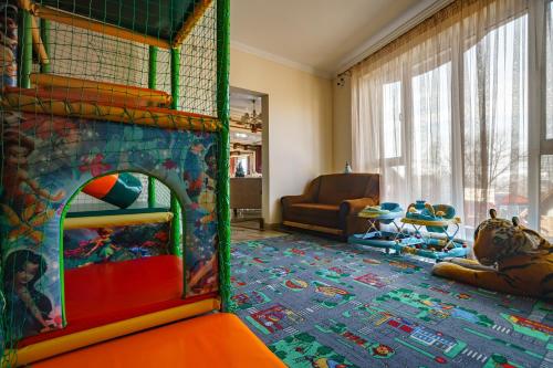 a living room with a play room with a fire place at SPA Resort HeRICH in Bukovel