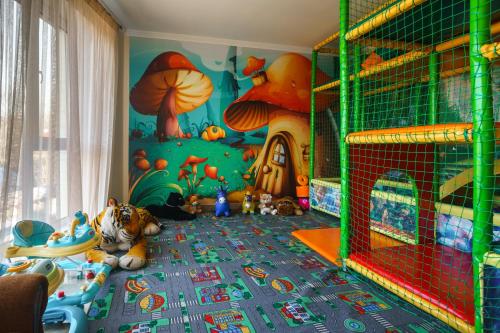 a childs room with a play area with a mural of mushrooms at SPA Resort HeRICH in Bukovel