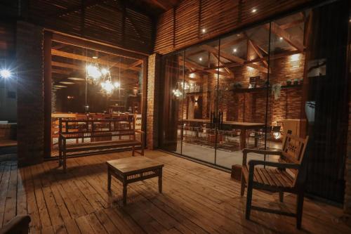 a room with two chairs and a table on a wooden floor at Ipê Hotel Express in Ponta Grossa