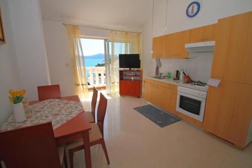 a kitchen with a table and a dining room with a view at Villa on the Sea Rock in Slano