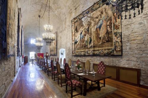 a dining room with a large painting on the wall at Parador de Hondarribia in Hondarribia