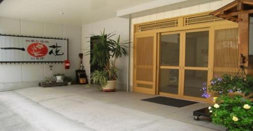 an entrance to a building with a door and plants at Ichigekan / Vacation STAY 8475 in Nakanojo