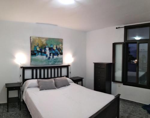 A bed or beds in a room at Central Seaview Apartment Puerto del Carmen