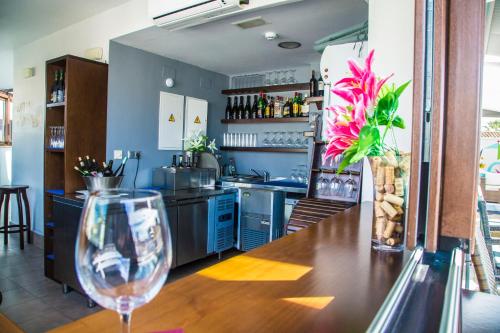 a kitchen with a table with a wine glass at Cordoba Carpe Diem in Córdoba