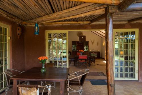 a dining room with a table and chairs at Kili Villa Kilimanjaro Luxury Retreat in Arusha