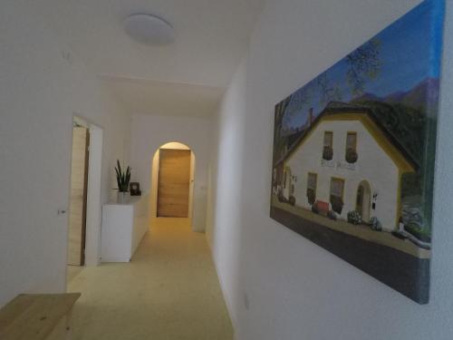 a painting of a house hanging on a wall at Haus Arnold - Privatzimmer und Ferienwohnungen in Sillian