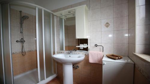 a bathroom with a sink and a shower at Bungalow Perla in Funtana
