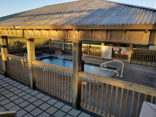a large wooden gazebo with a swimming pool at The Inn on Pamlico Sound in Buxton