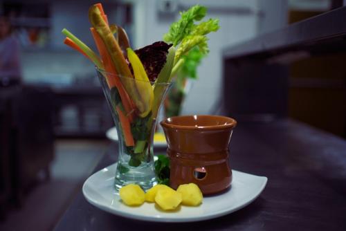 a vase on a plate with carrots and other vegetables at Grand Hotel Sestriere in Sestriere