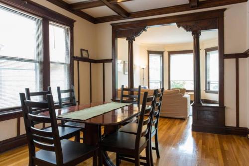 a dining room with a wooden table and chairs at Wrigley Oasis! Steps from the Field! - 3BD 1BA in Chicago