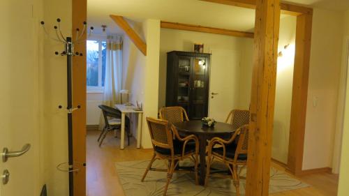 a dining room with a table and chairs at Ferienwohnung Loma in Bad Harzburg